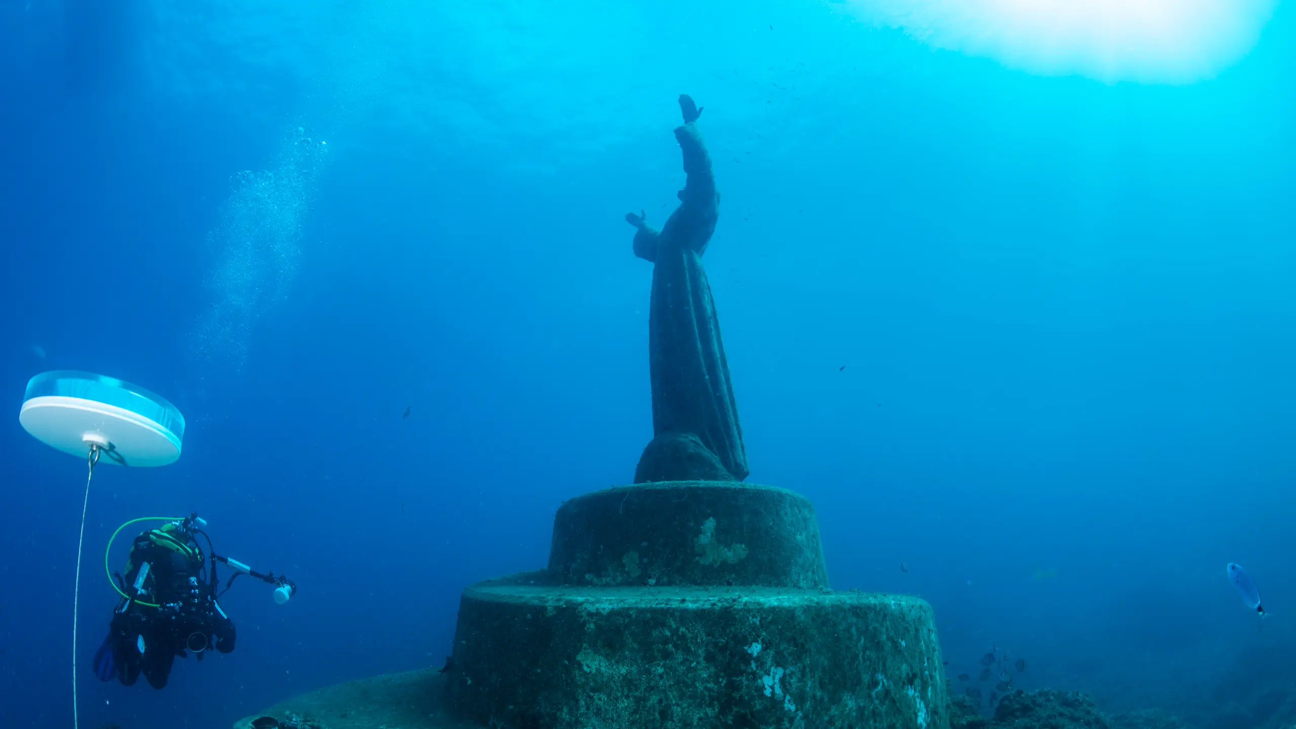 underwater photo of a statue of Jesus Christ