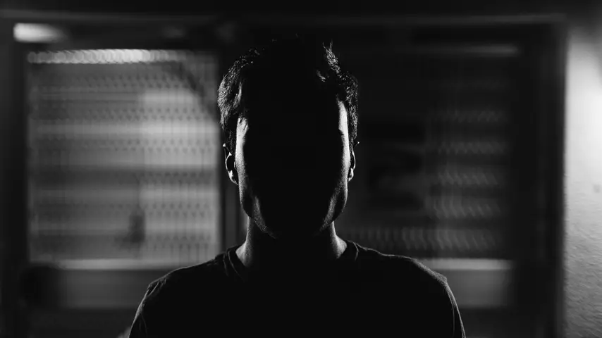 photo of a man's face obscured by shadows