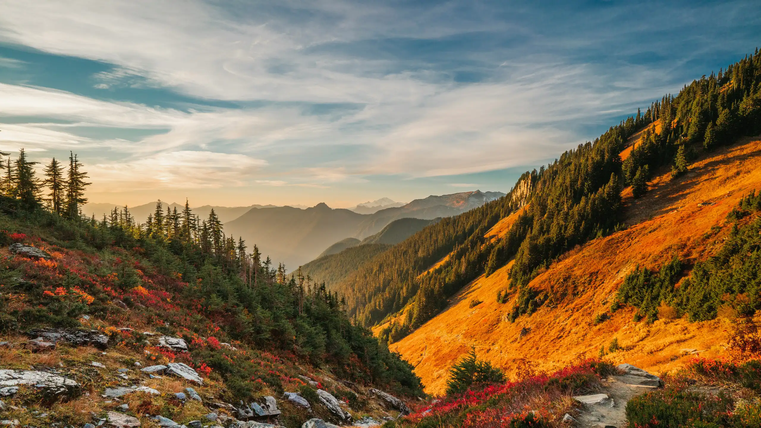 green and brown mountains under white clouds and blue sky