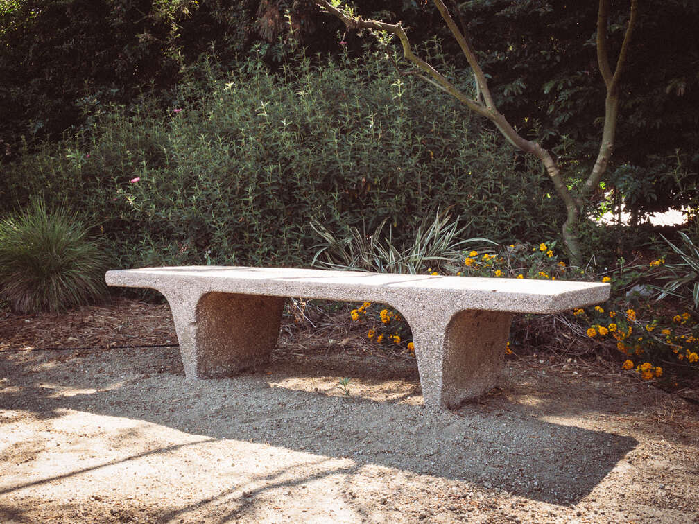 Photo of a bench next to a foot path